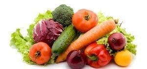 Assortment of fresh vegetables including lettuce, cabbage, broccoli, tomatoes, carrots, cucumber, and peppers.