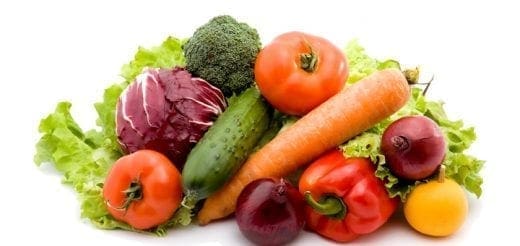 Assortment of fresh vegetables including lettuce, cabbage, broccoli, tomatoes, carrots, cucumber, and peppers.