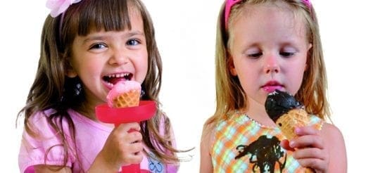 Two children eating ice cream cones.