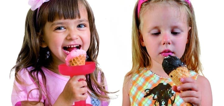 Two children eating ice cream cones.