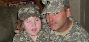 Elaina Faith and her father in camouflage uniforms.