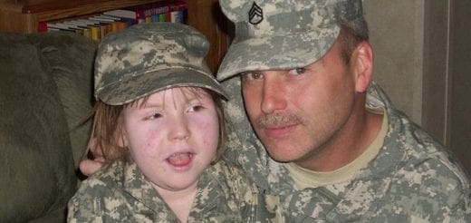 Elaina Faith and her father in camouflage uniforms.