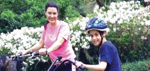 William and Korky with bicycles outdoors.