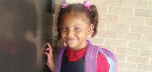 Mariana Pacheco smiles, wearing a school uniform and a backpack.