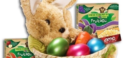 Easter basket with a plush bunny, colorful eggs, and fruit snacks.