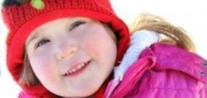 Cheyenne Emily wearing a red hat and pink coat.
