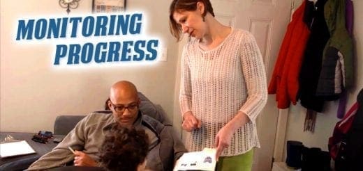 Man and woman looking at papers with "MONITORING PROGRESS" text overlay