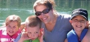 Dani Wykes with three children on a boat.