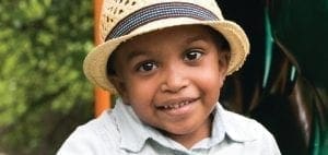 Kole Thomas Garrett wearing a straw hat and a collared shirt.