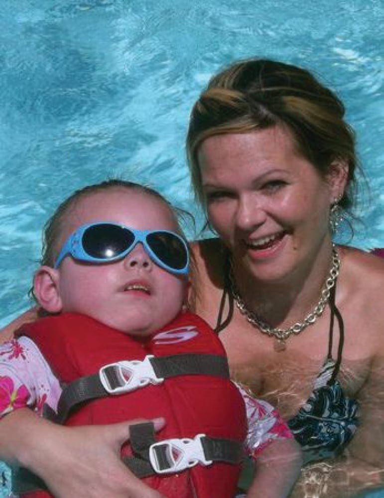 Cynthia LeDoux Campobasso with Baybeblue in a swimming pool.