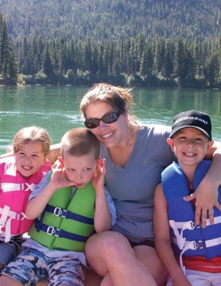 Dani Wykes with Parker, Presten, and Keelie on a boat.