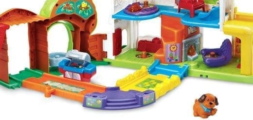 A colorful toy house with a small dog figurine.