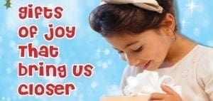 Child looking down at a gift against a blue, snowy background with the text Gifts of Joy That Bring Us Closer.