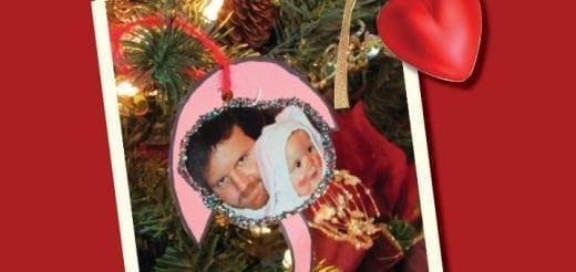 Christmas ornament with photos of a man and a baby.