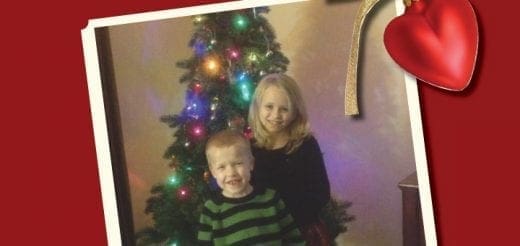 Children posing in front of a decorated Christmas tree.