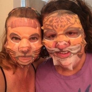 Two people wearing animal-themed face masks.