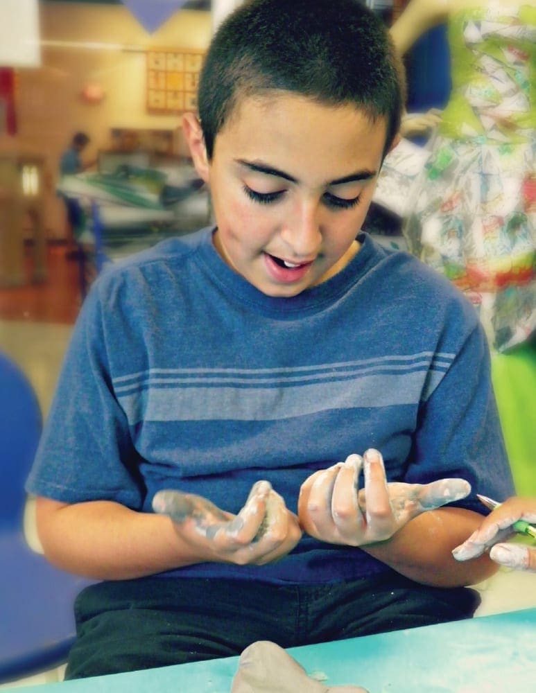 Sebastian exploring clay at a Miami Children's Museum Sensory Saturday.
