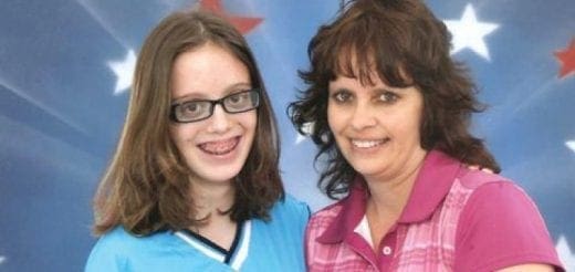 Lindsey and an adult woman smile against a patriotic background.
