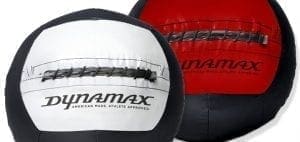 Two Dynamax medicine balls, one white and one red.