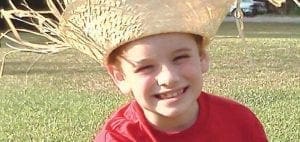 Ryan Carl Wasser wearing a straw hat and red shirt.