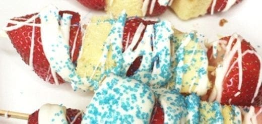 Strawberry poundcake kabobs with white chocolate drizzle and blue sprinkles.