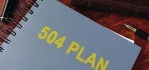 A blue notebook with "504 PLAN" in yellow lettering.