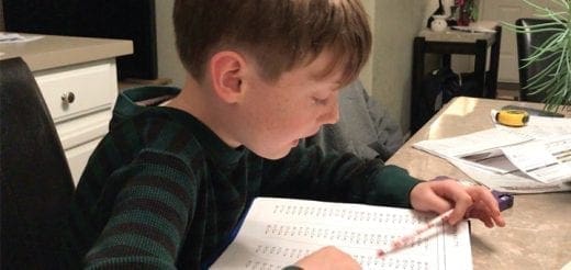 Boy doing homework at a table