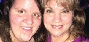 Two women smiling at the camera.