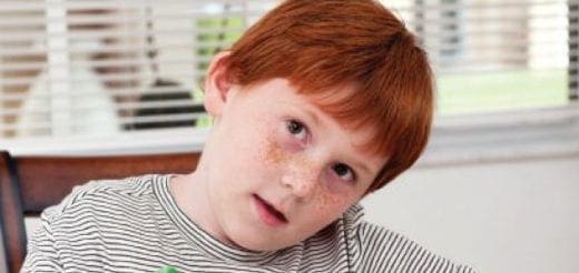 Ayden McCann looking up from a striped shirt.