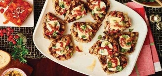 Small appetizers with toasted bread, eggs, and herbs on a white platter.