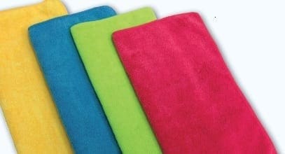 Four colorful folded towels, yellow, blue, green, and pink.