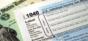 U.S. individual income tax form 1040 and a U.S. Treasury check.