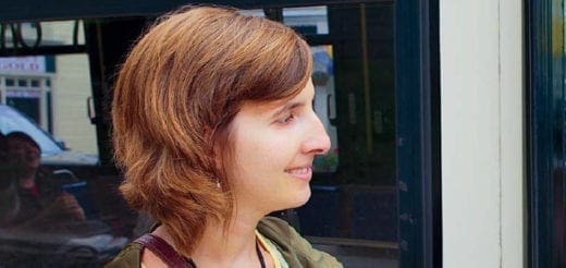 Lesley University student smiles while looking out a window.