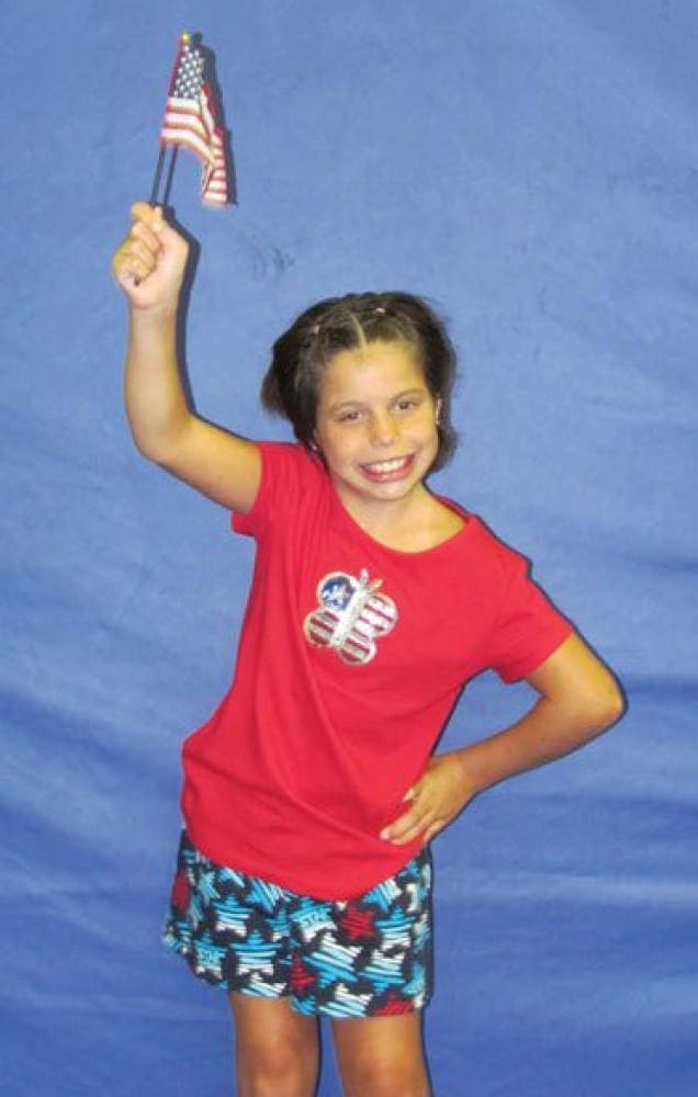 Gabrielle Ioffredo holding an American flag.