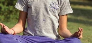 Person meditating outdoors in a yoga pose