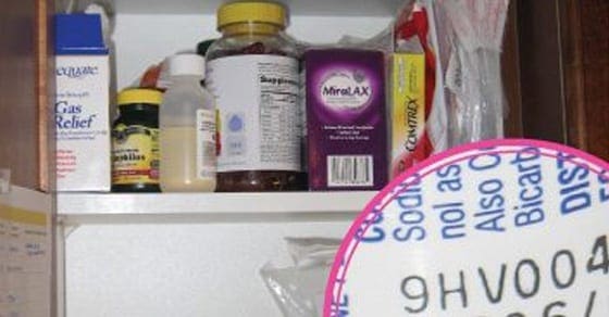 Shelves stocked with various medicine bottles and boxes.
