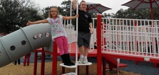 Two children on a playground structure.