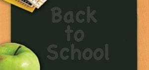 Chalkboard with text "Back to School," a green apple, and books