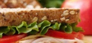 A close-up of a sandwich with lettuce and tomato.