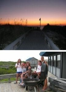 Family and friends gather around a grill on a deck with a beach boardwalk and sunset in the background.