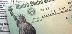 Close-up of a United States Treasury check with the Statue of Liberty.