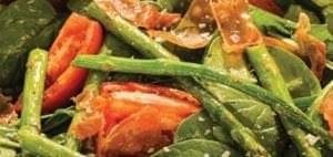 Spinach salad with asparagus and tomatoes.