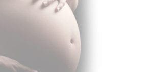 Pregnant belly with hands resting on it