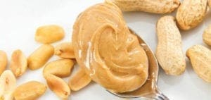 Spoonful of peanut butter with peanuts