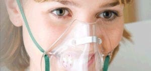 Close-up of a person wearing an oxygen mask.