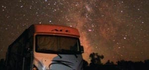 Camper van under a starry night sky