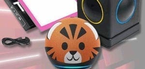 A small, round device with a tiger face design sits on a surface next to a USB cable and a box.