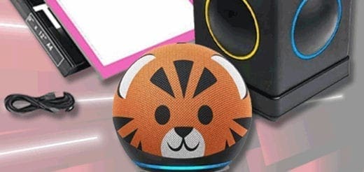 A small, round device with a tiger face design sits on a surface next to a USB cable and a box.