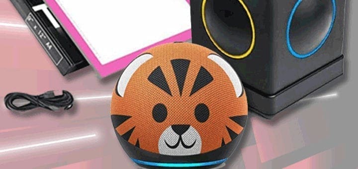 A small, round device with a tiger face design sits on a surface next to a USB cable and a box.