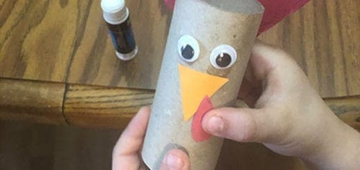 A toilet paper roll turkey craft with googly eyes and paper beak and wattle.